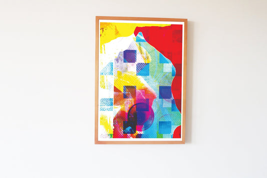 Framed abstract artwork with colorful geometric design on a white wall