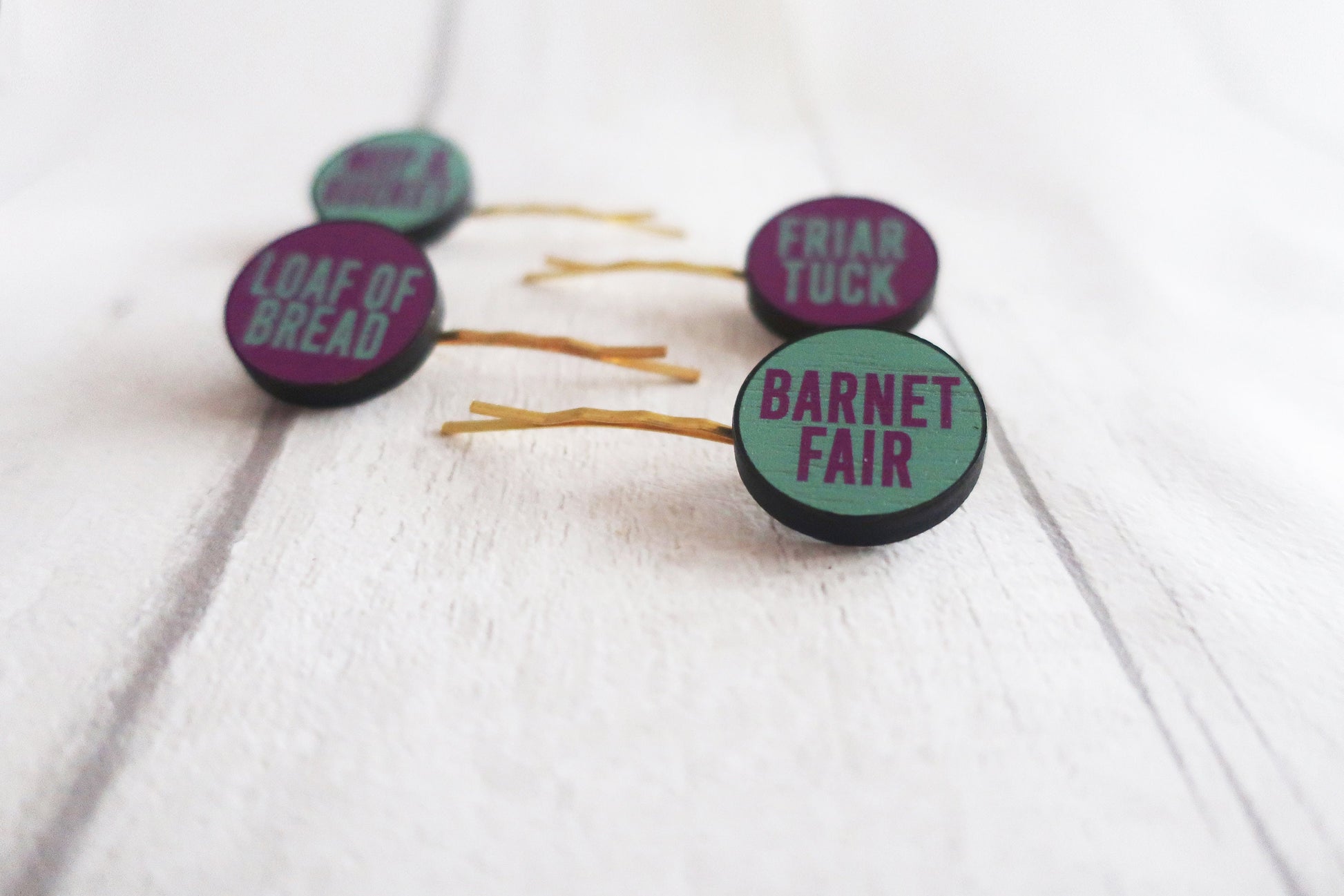 Three hairpins with text on a white background