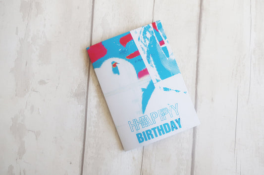 Colorful birthday card with a abstract design on a light wooden surface