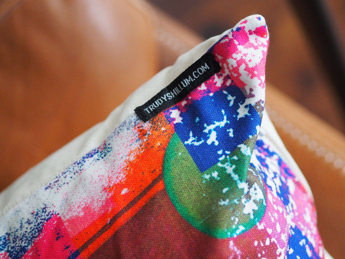 Colorful pillow with a brand label on a blurred background