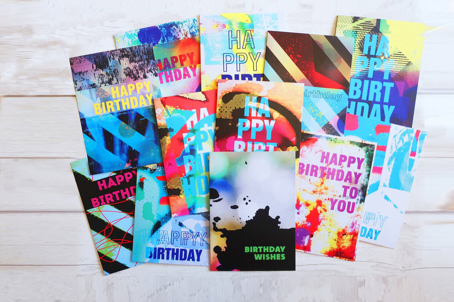 Collection of colorful birthday cards on a wooden surface