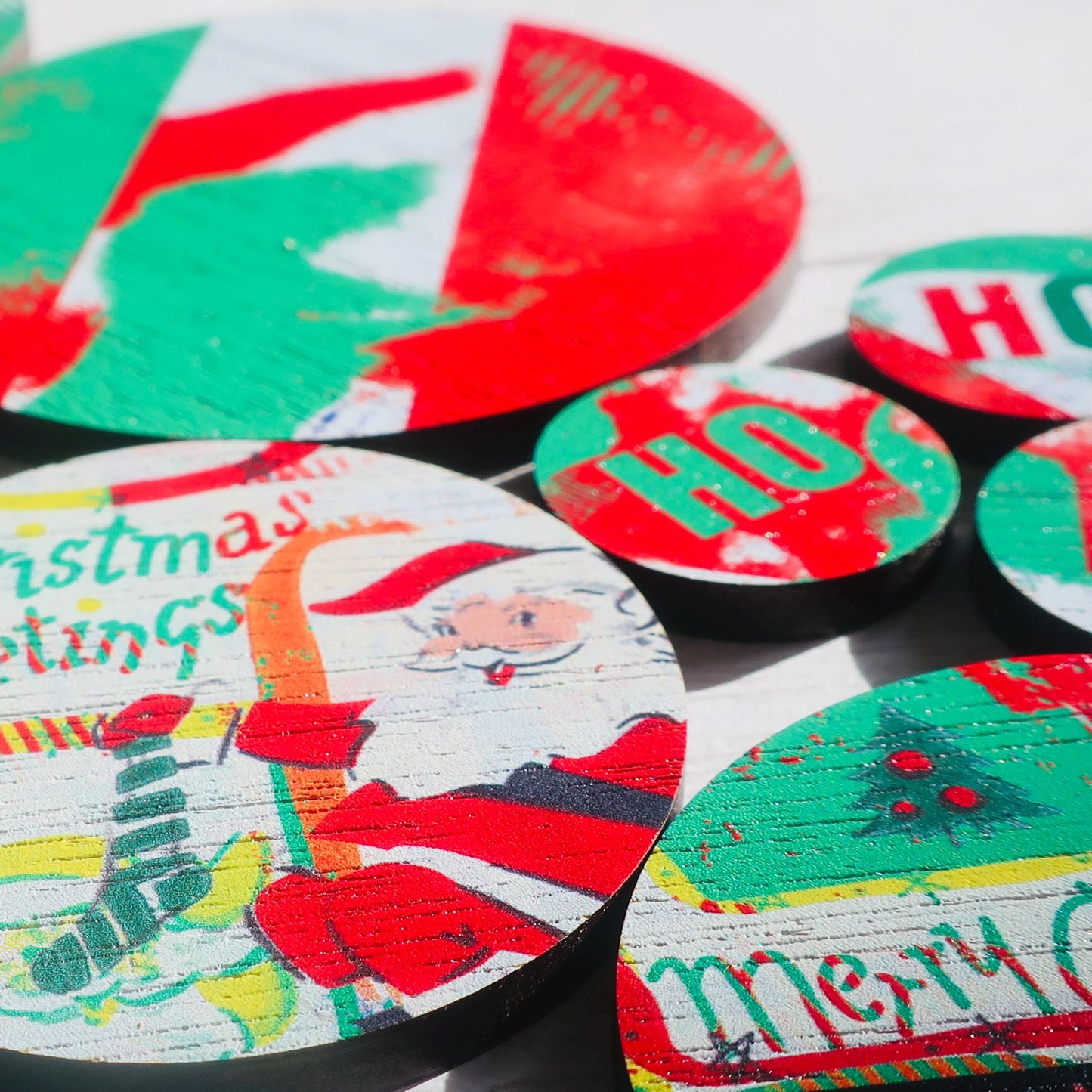 Collection of festive badges with Christmas designs including Santa Claus and 'Merry Christmas' text.