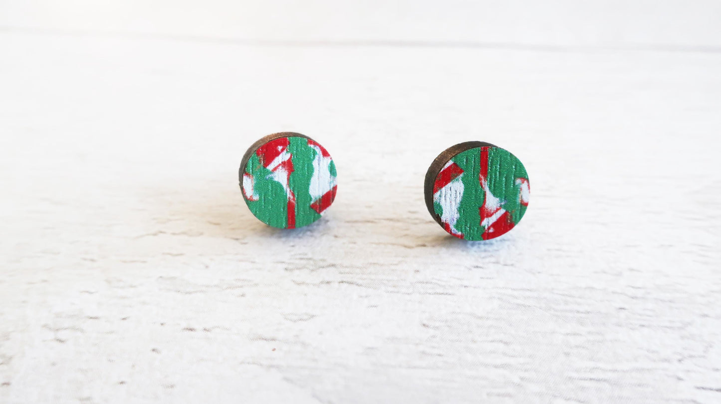Pair of round earrings with green and red pattern on a white background