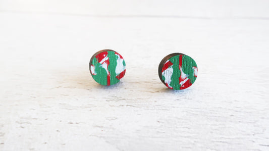 Pair of round earrings with green and red pattern on a white background