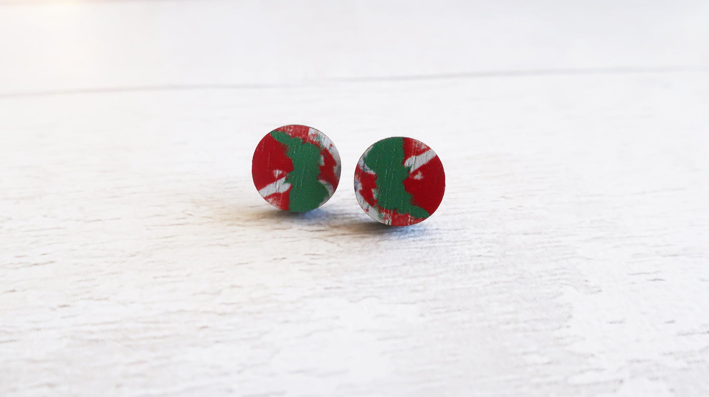 Round earrings with red, green, and white pattern on a white background