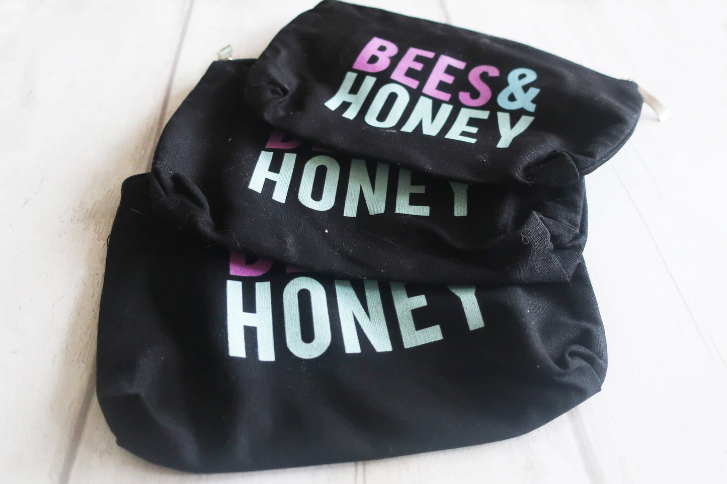 Black bag with 'BEES & HONEY' text on a white background