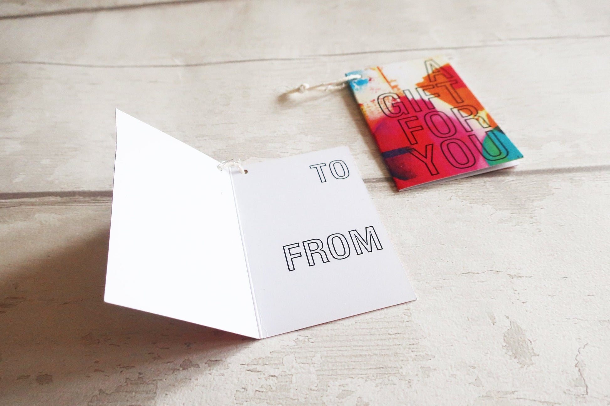 Greeting card with 'To' and 'From' text on a wooden surface