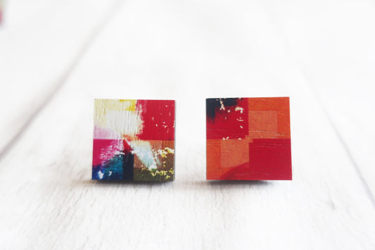 Colorful square stud earrings on a white background