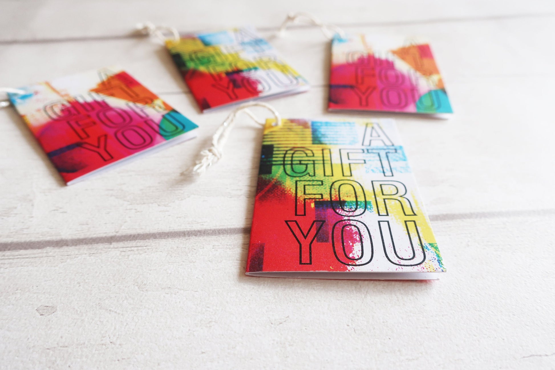 Colorful gift card with 'A Gift For You' text on a white surface