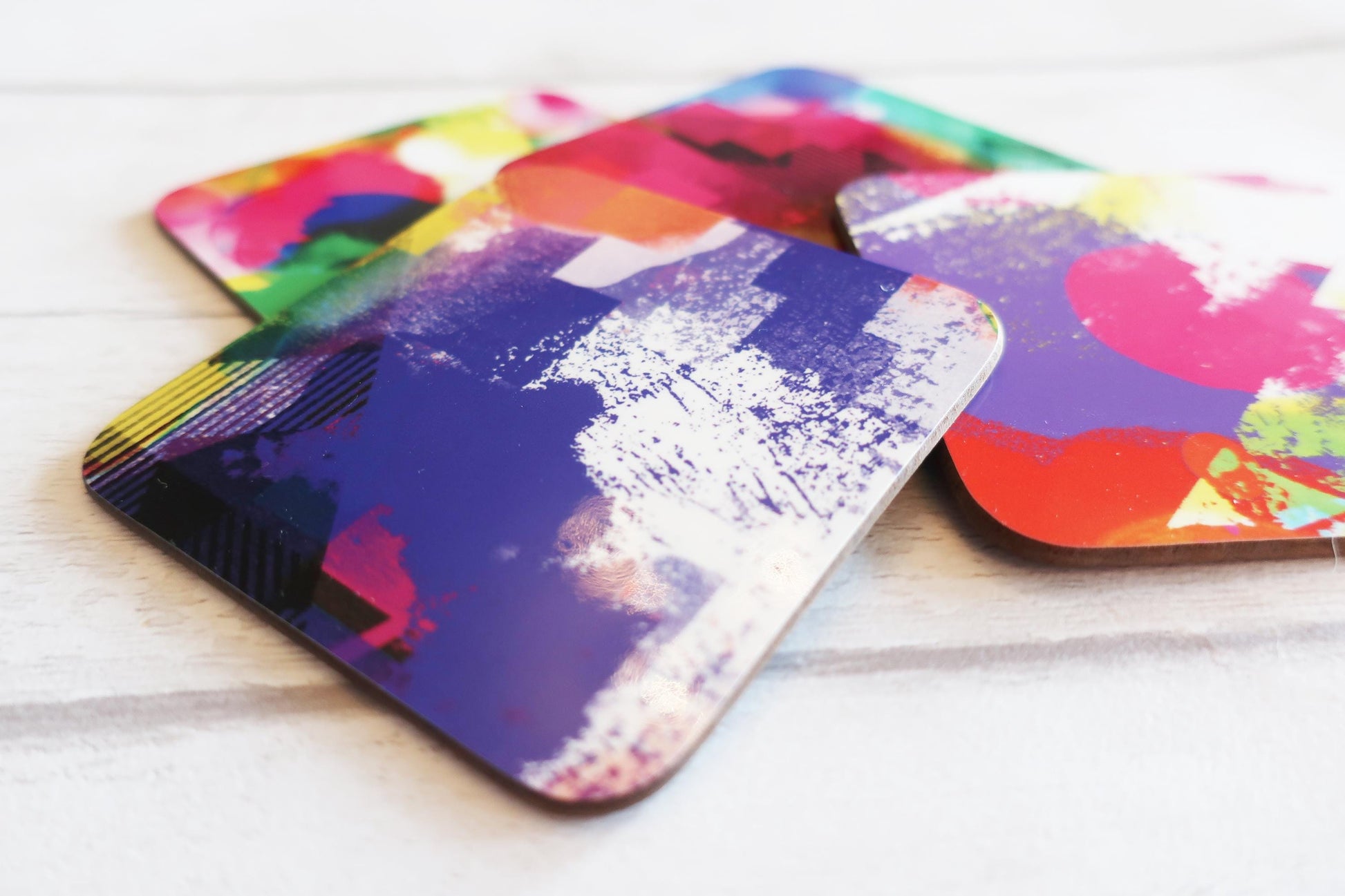 Colorful abstract coasters on a white surface