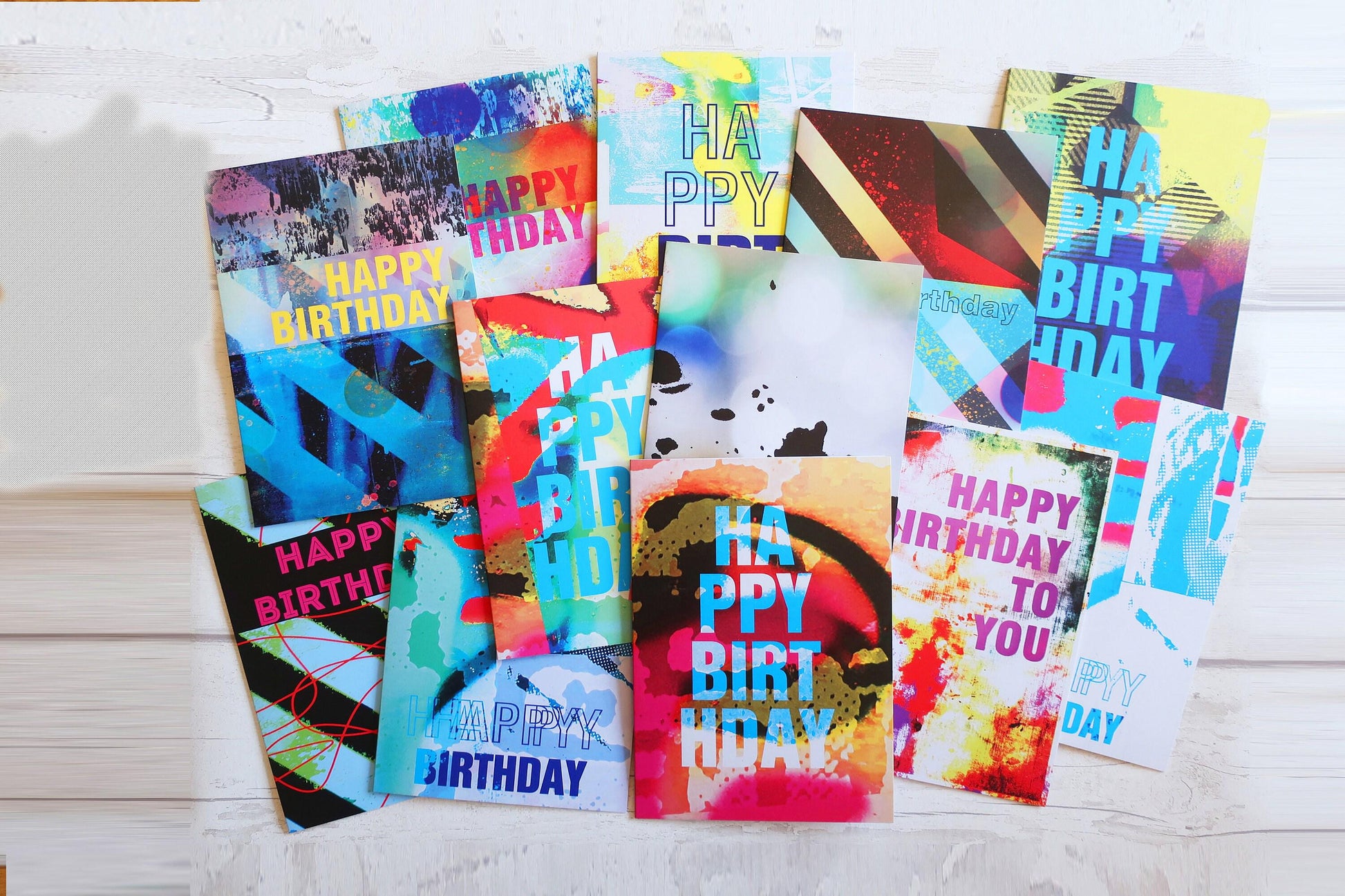 Collection of colorful birthday cards on a white surface