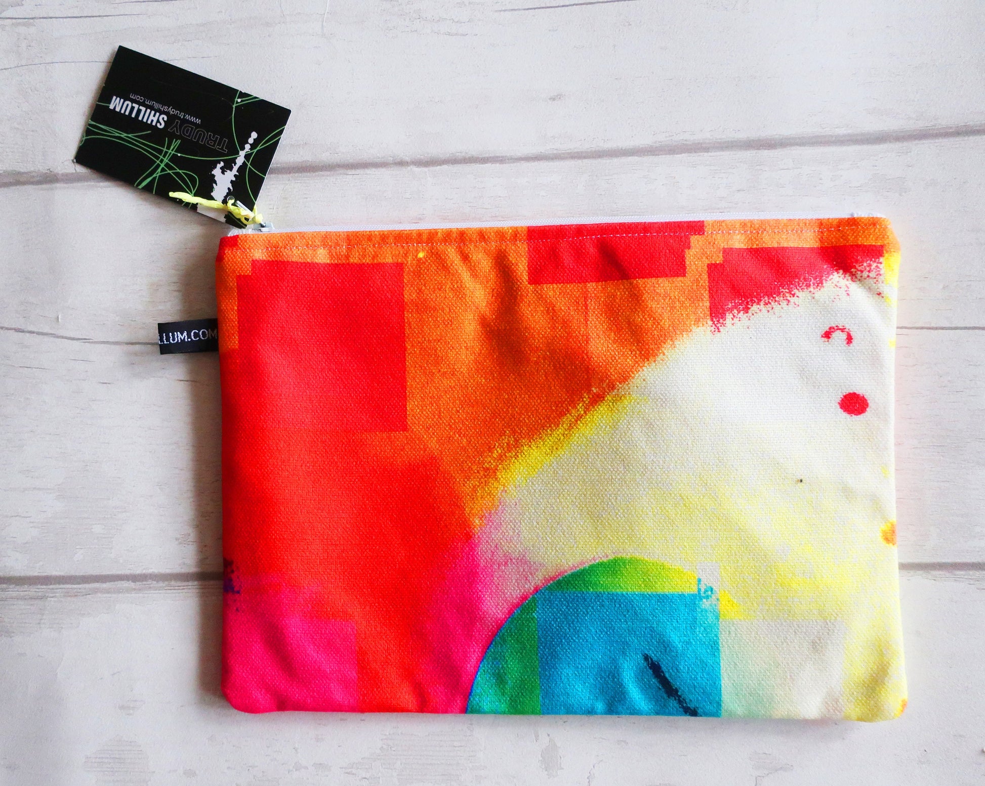 Colorful pouch with a rainbow design on a light wooden surface