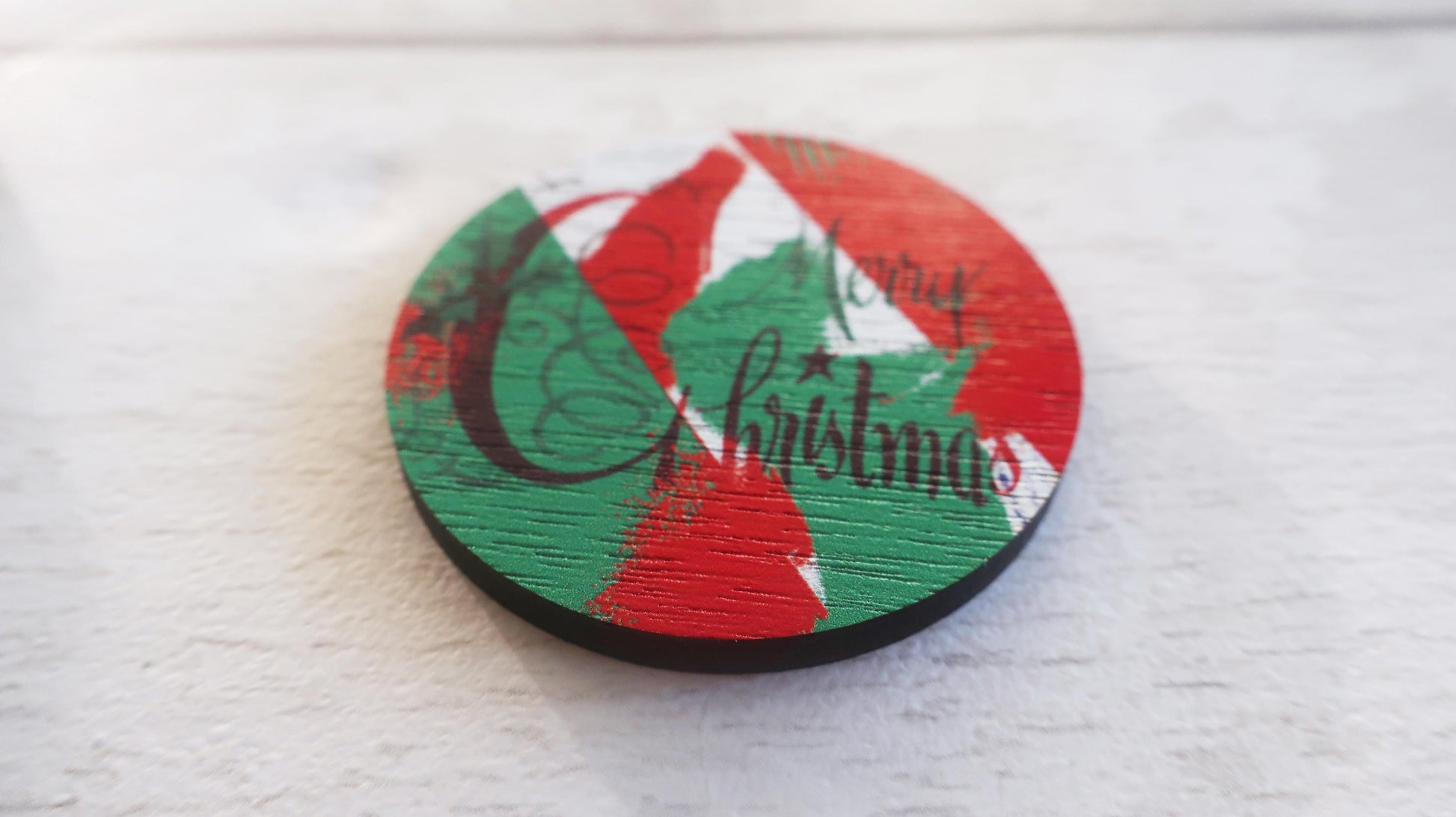 Round Christmas-themed badge with red, green, and white colors on a white background