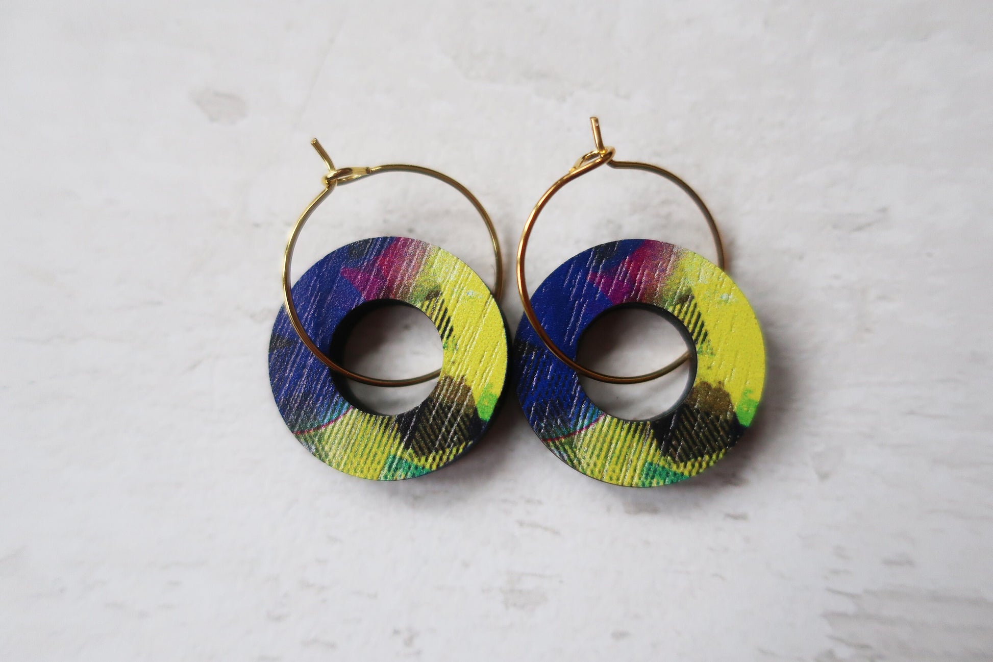 Colorful hoop earrings on a light gray background
