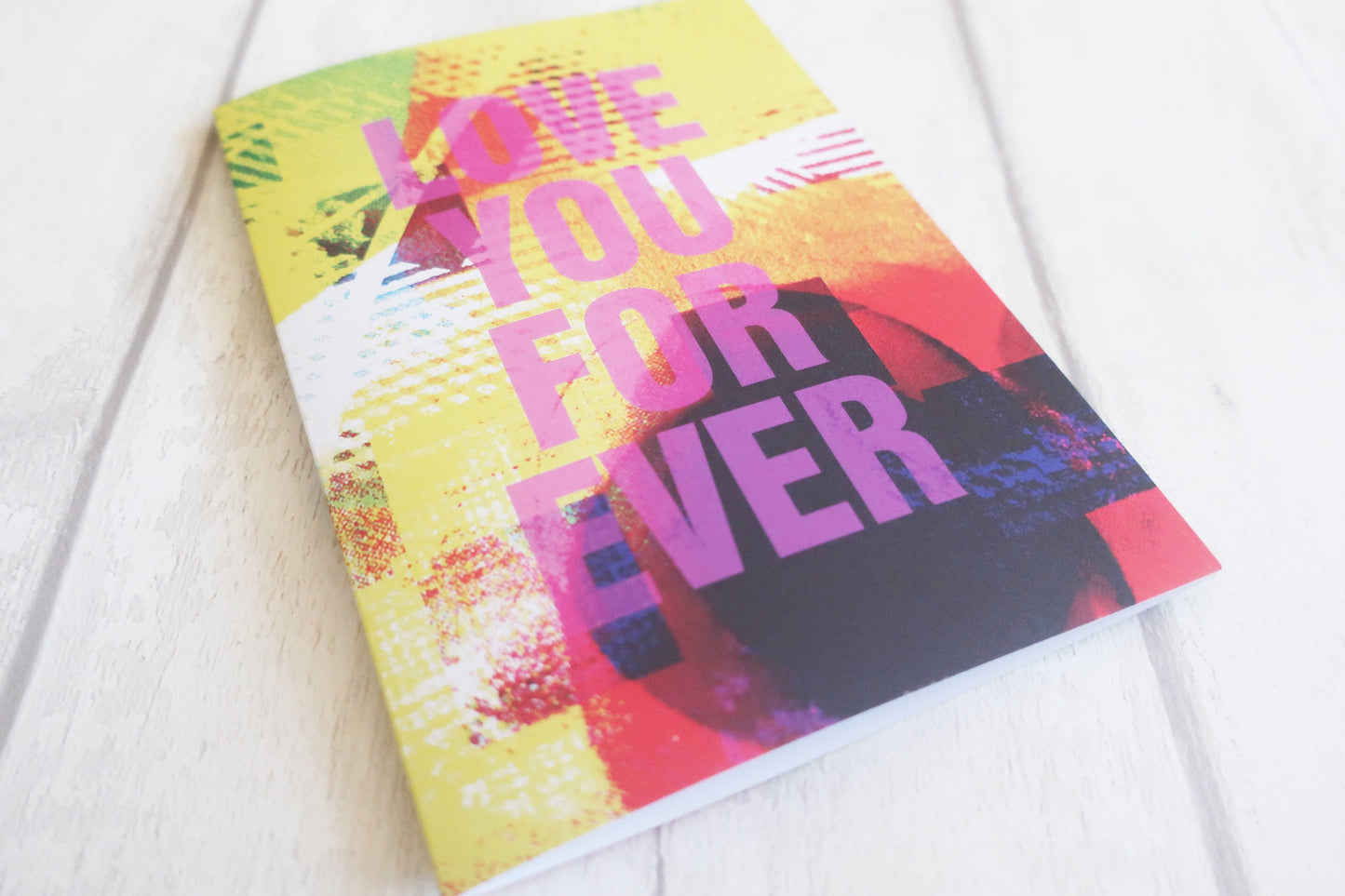 Colorful card with 'Love You Forever' text on a white surface