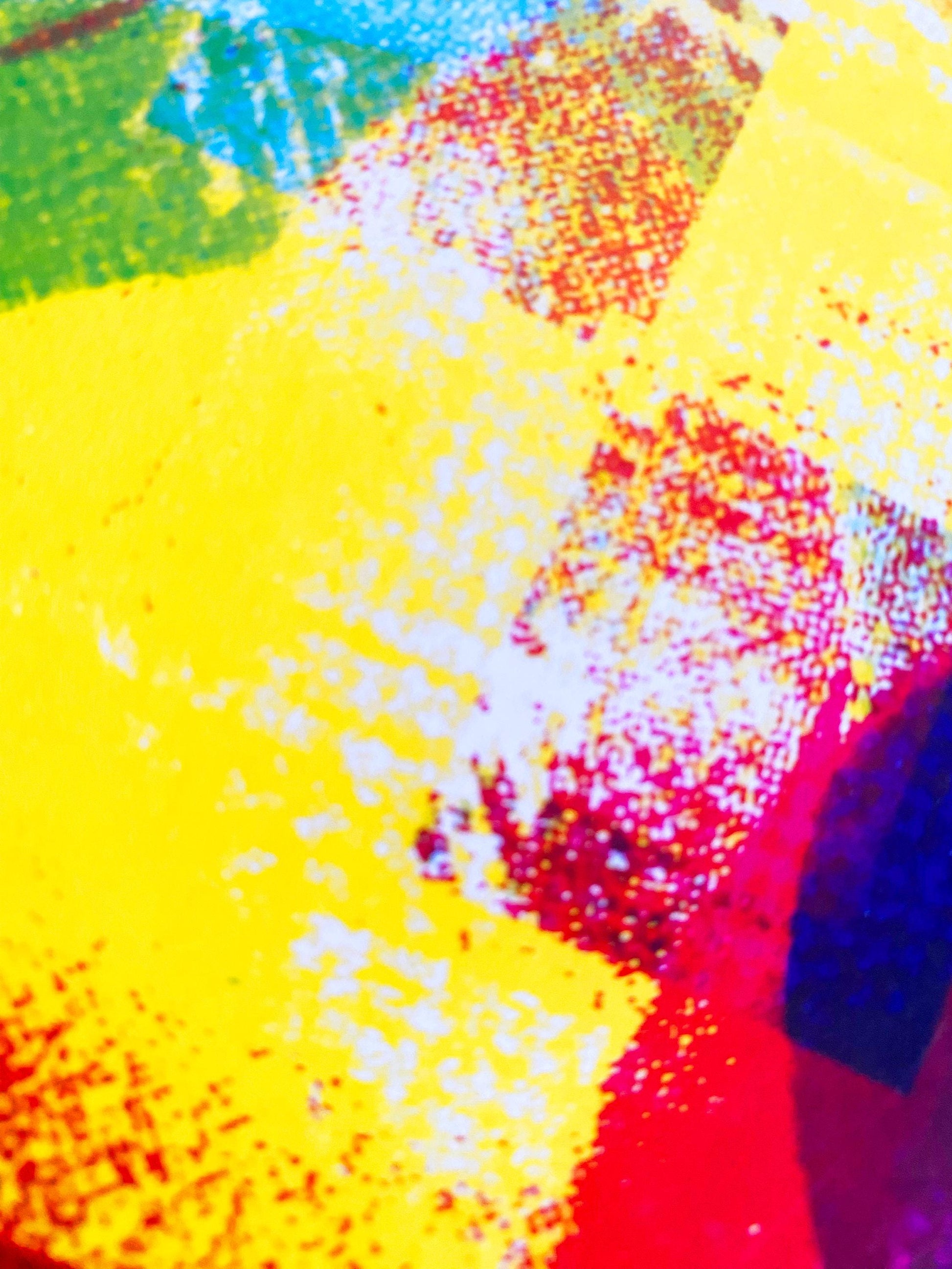 Close-up of a colorful abstract painting with bright yellow, red, and blue.