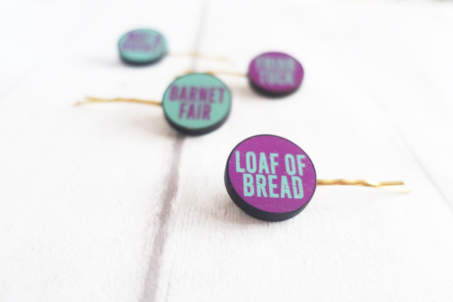 Colorful hairclips with text on a white background
