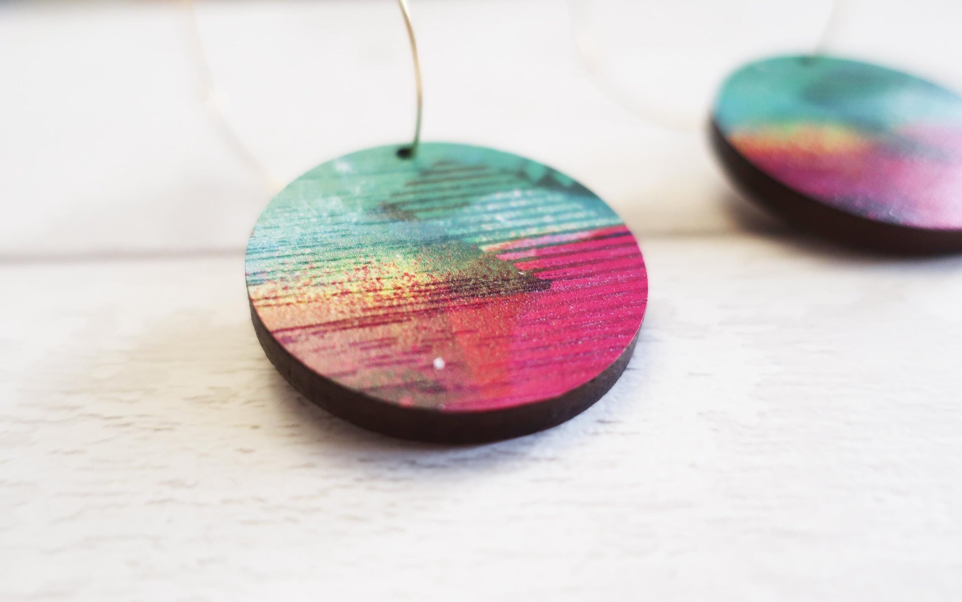 Colorful circular earrings on a white background