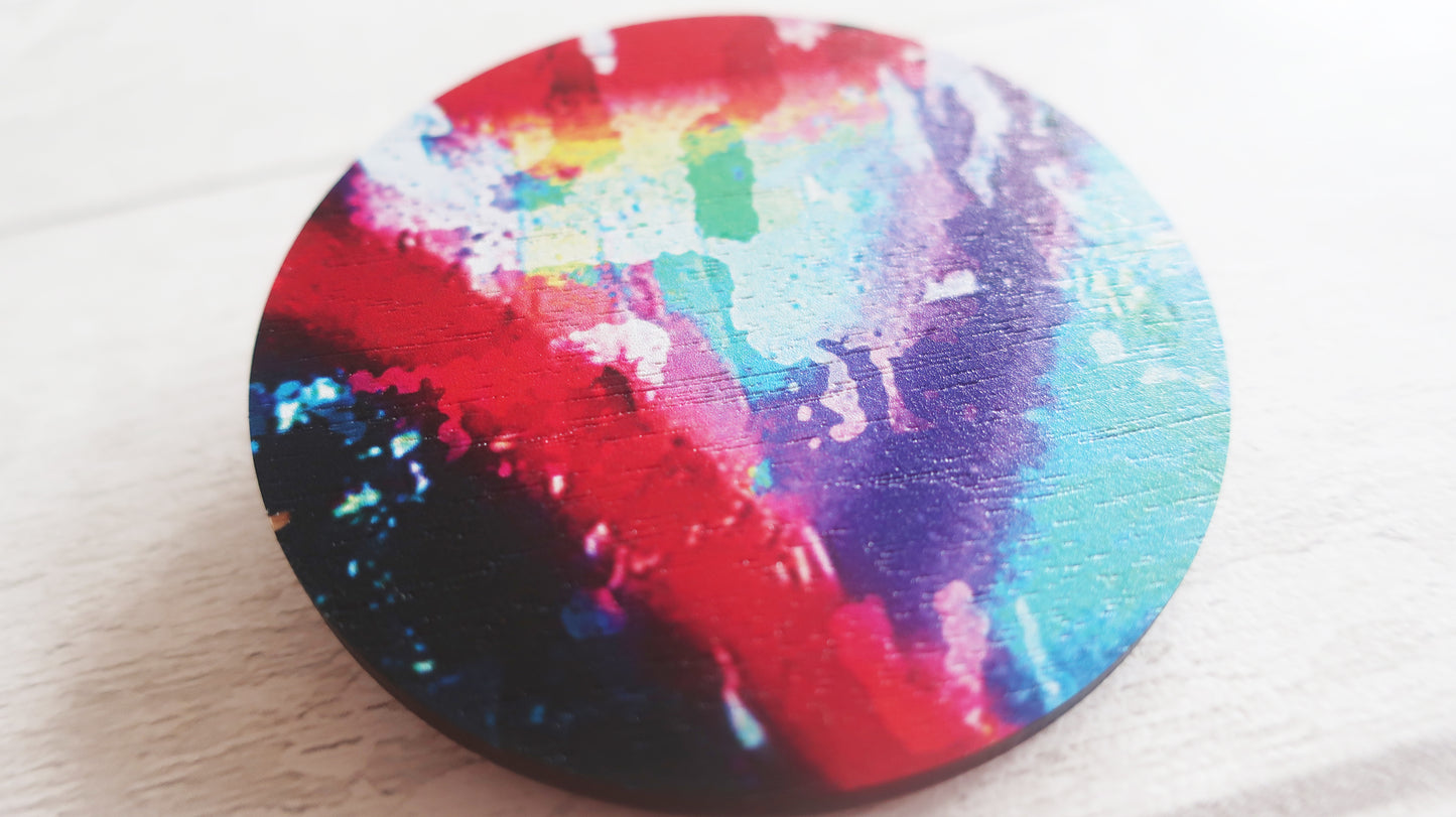 Colorful circular brooch with a multicolored pattern on a white background