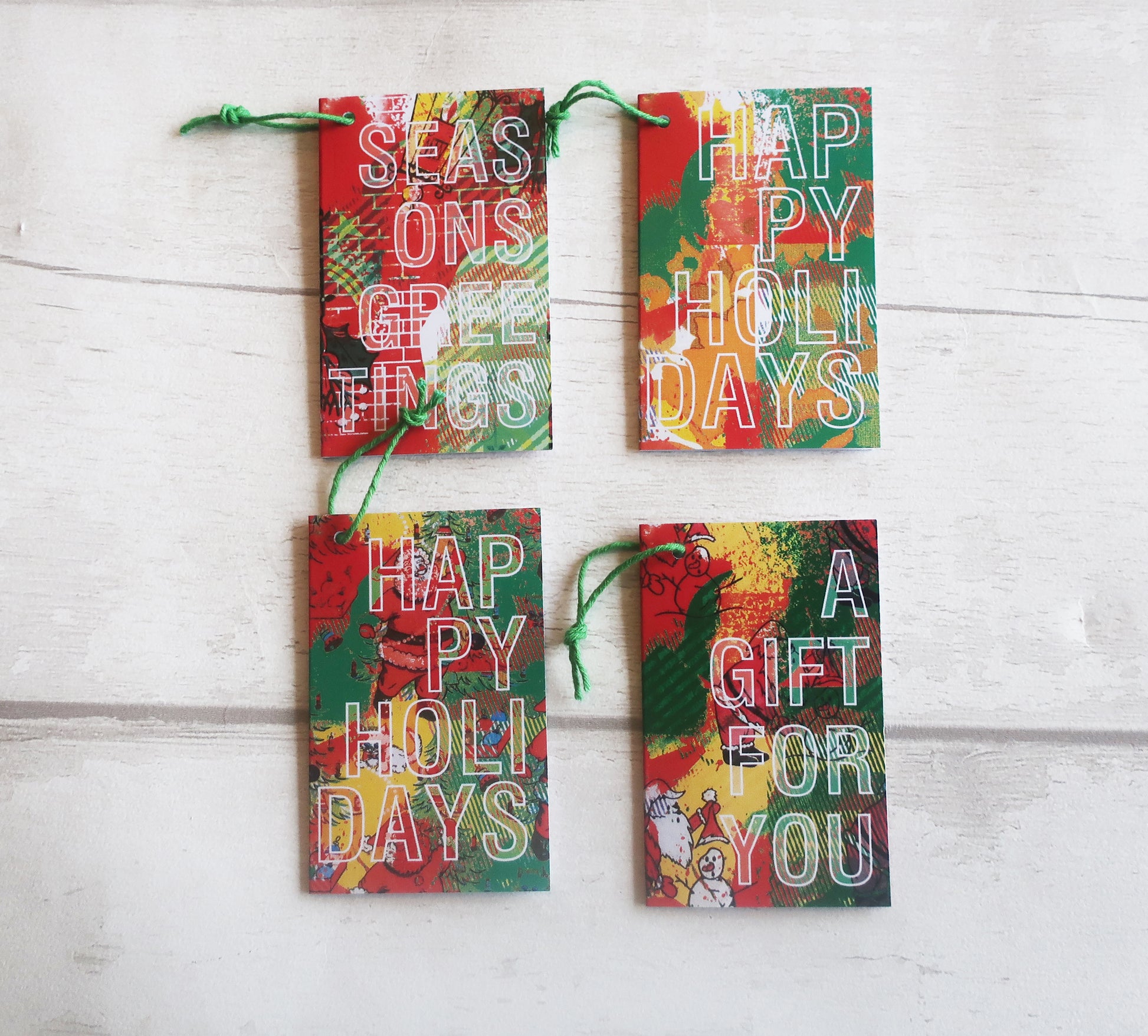 a set of 4 Christmas gift tags on a white wooden background