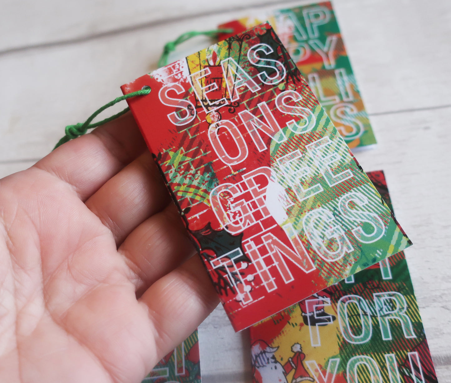 A Christmas gift tag held in a hand