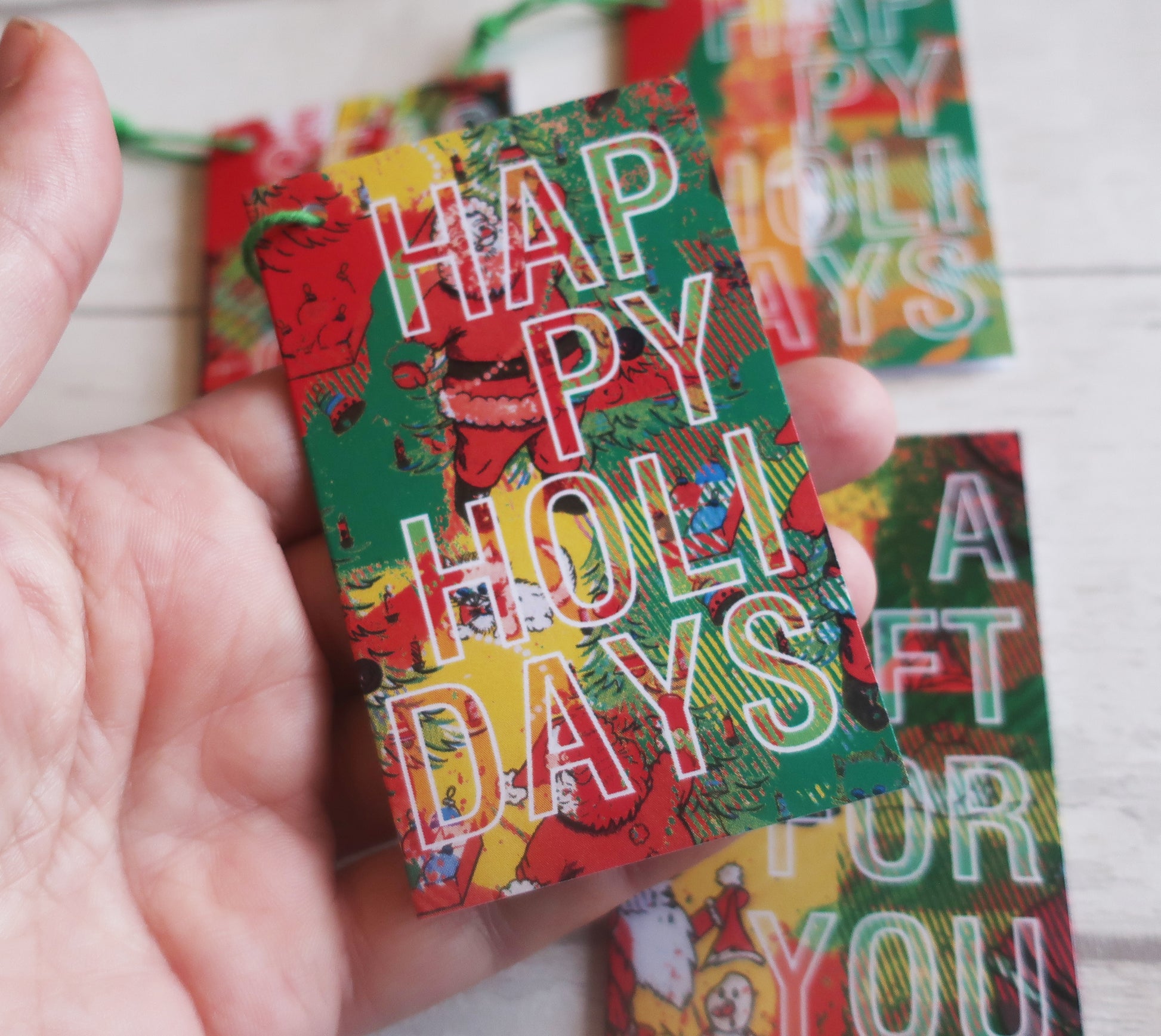 A Christmas gift tag held in a hand