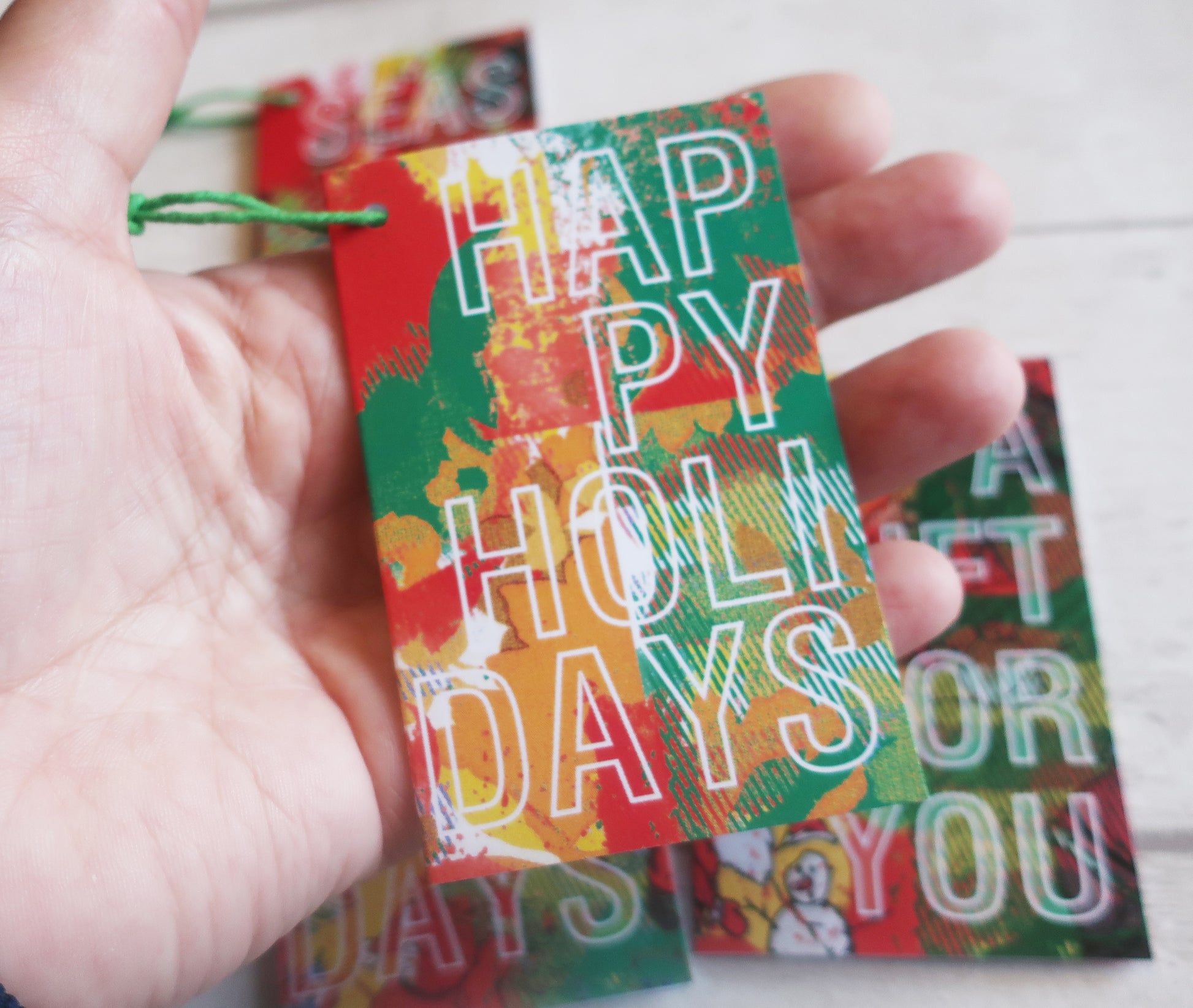 A Christmas gift tag held in a hand