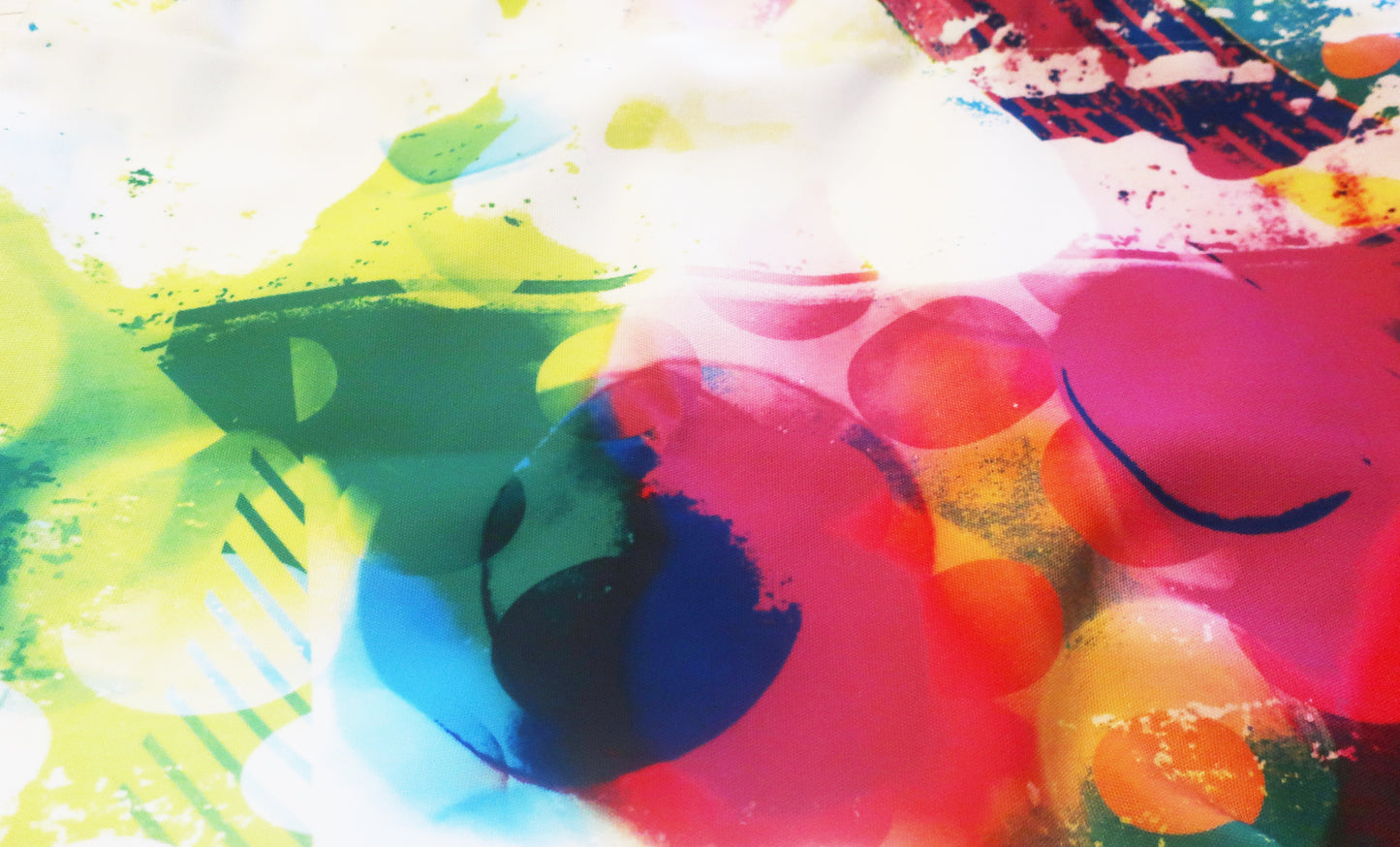 Abstract fabric with colorful splashes of paint on a white background