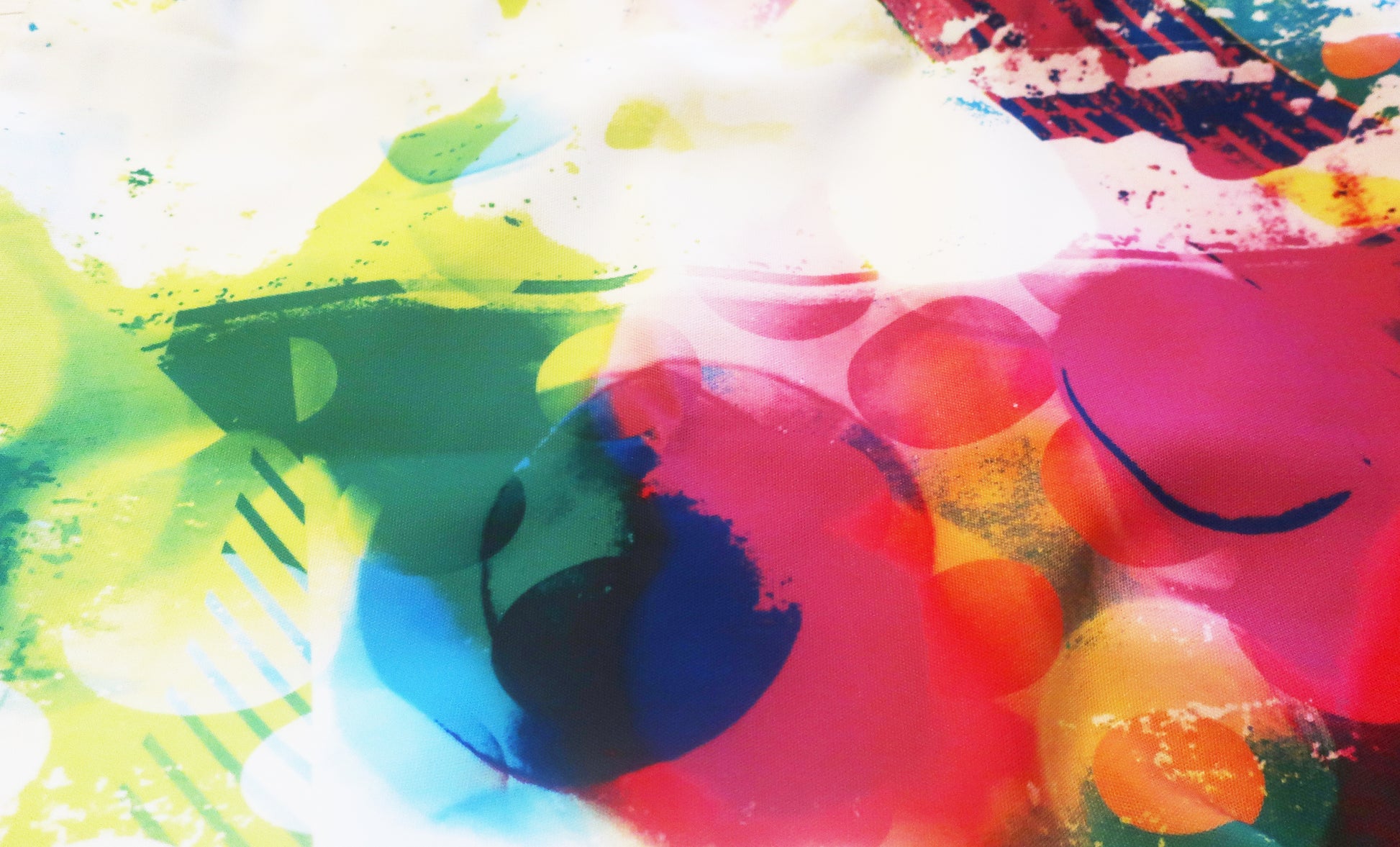 Abstract fabric with colorful splashes of paint on a white background