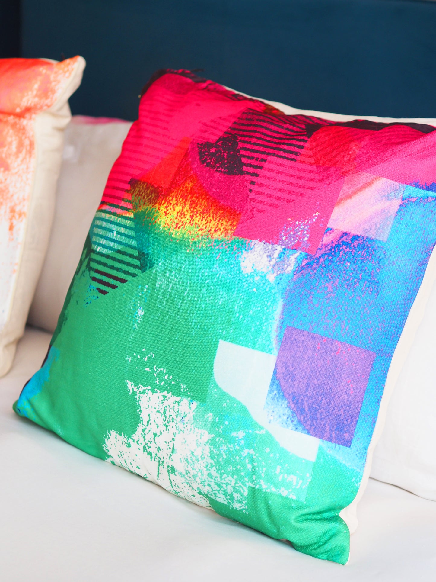 Colorful abstract-patterned pillow on a white couch