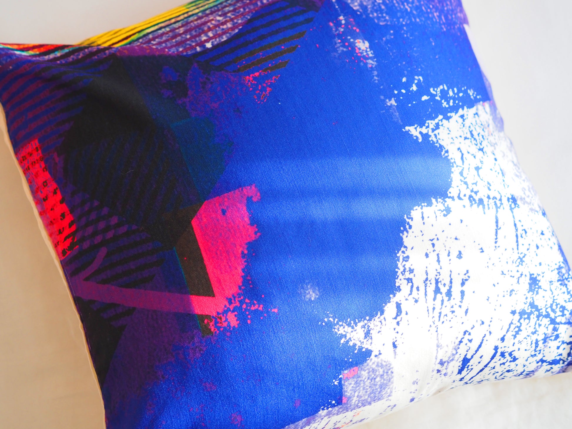 Colorful cushion with abstract patterns on a white background