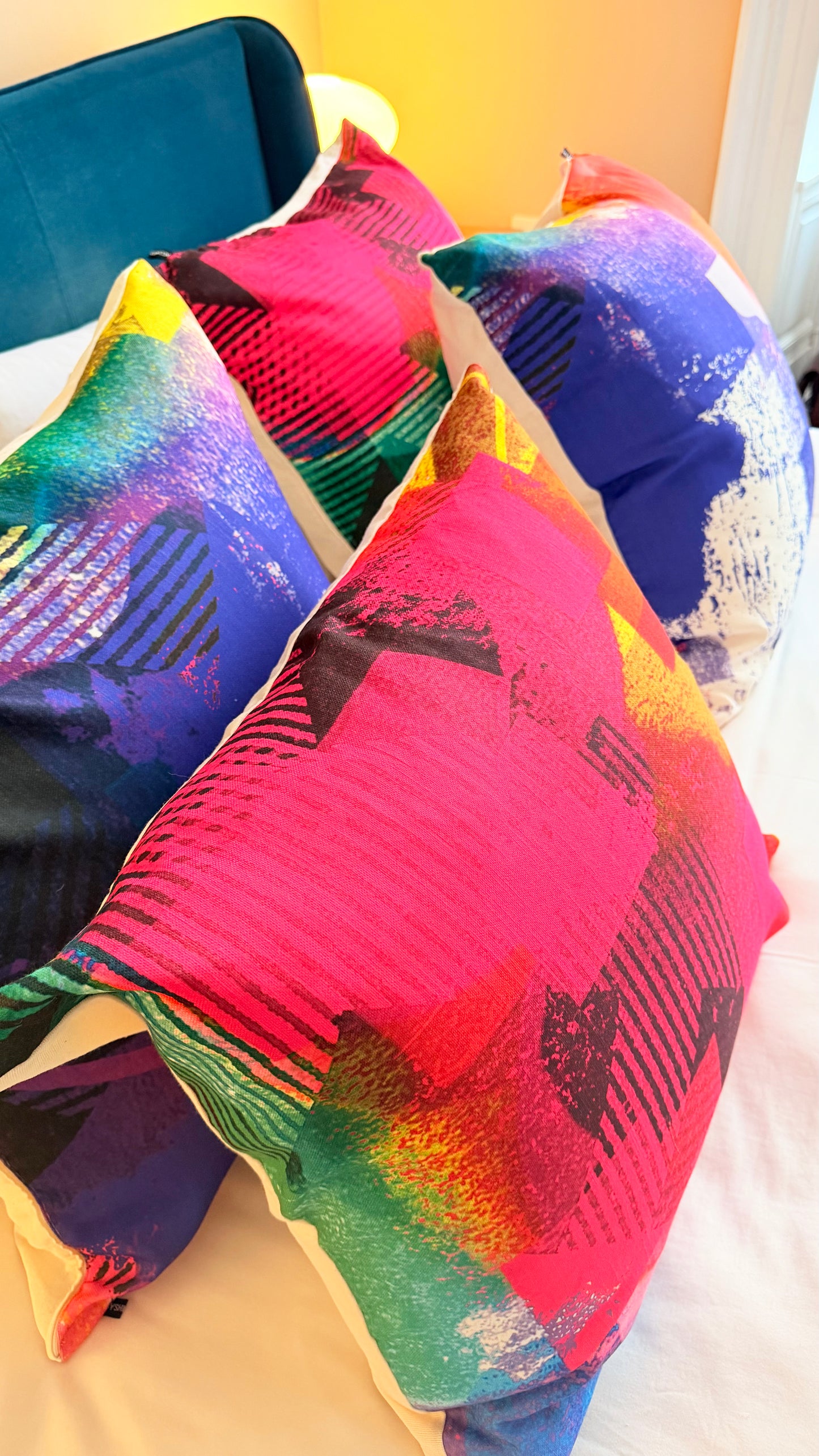 Colorful pillows with abstract patterns on a chair