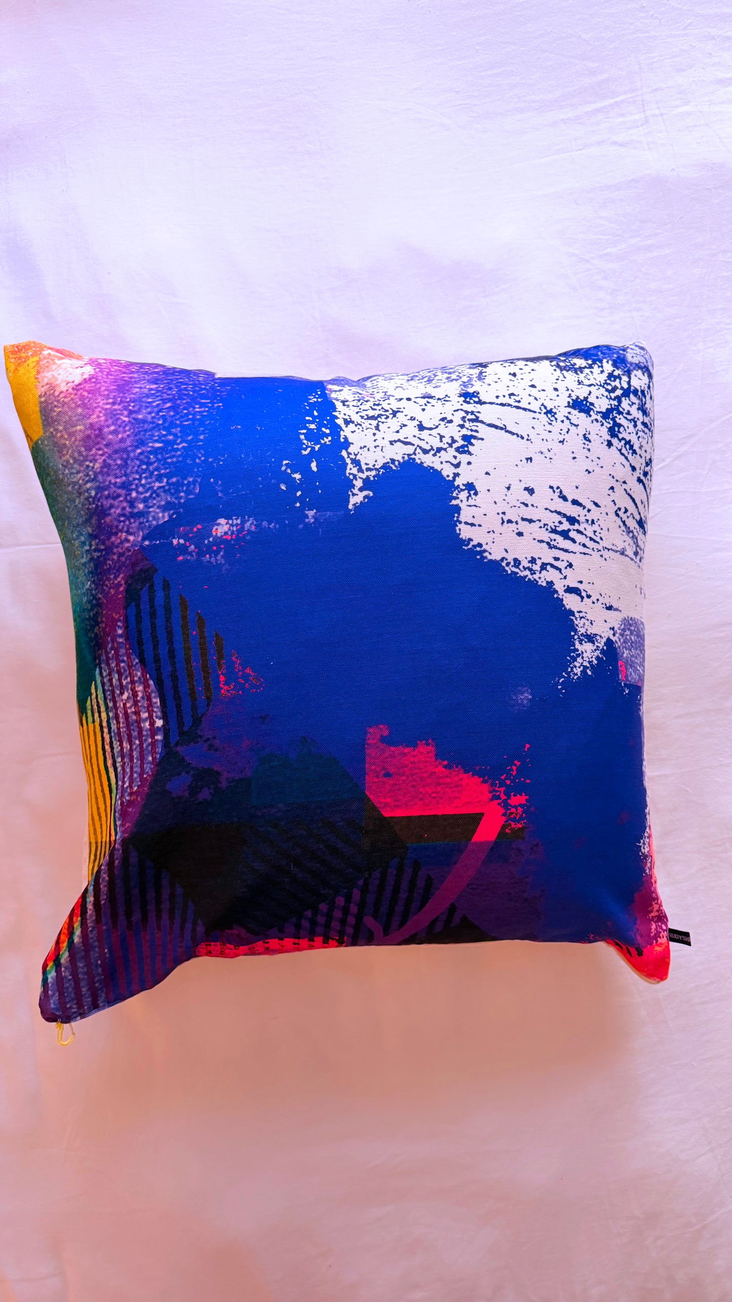 Colorful abstract pillow on a white surface