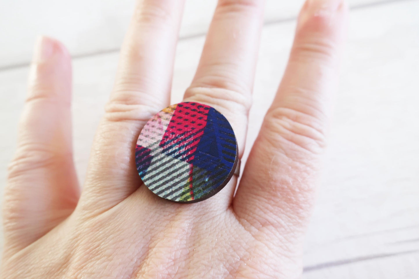 Multicolored ring on a hand with a light background