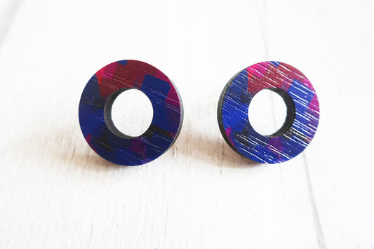 Pair of round earrings with colorful design on a white background