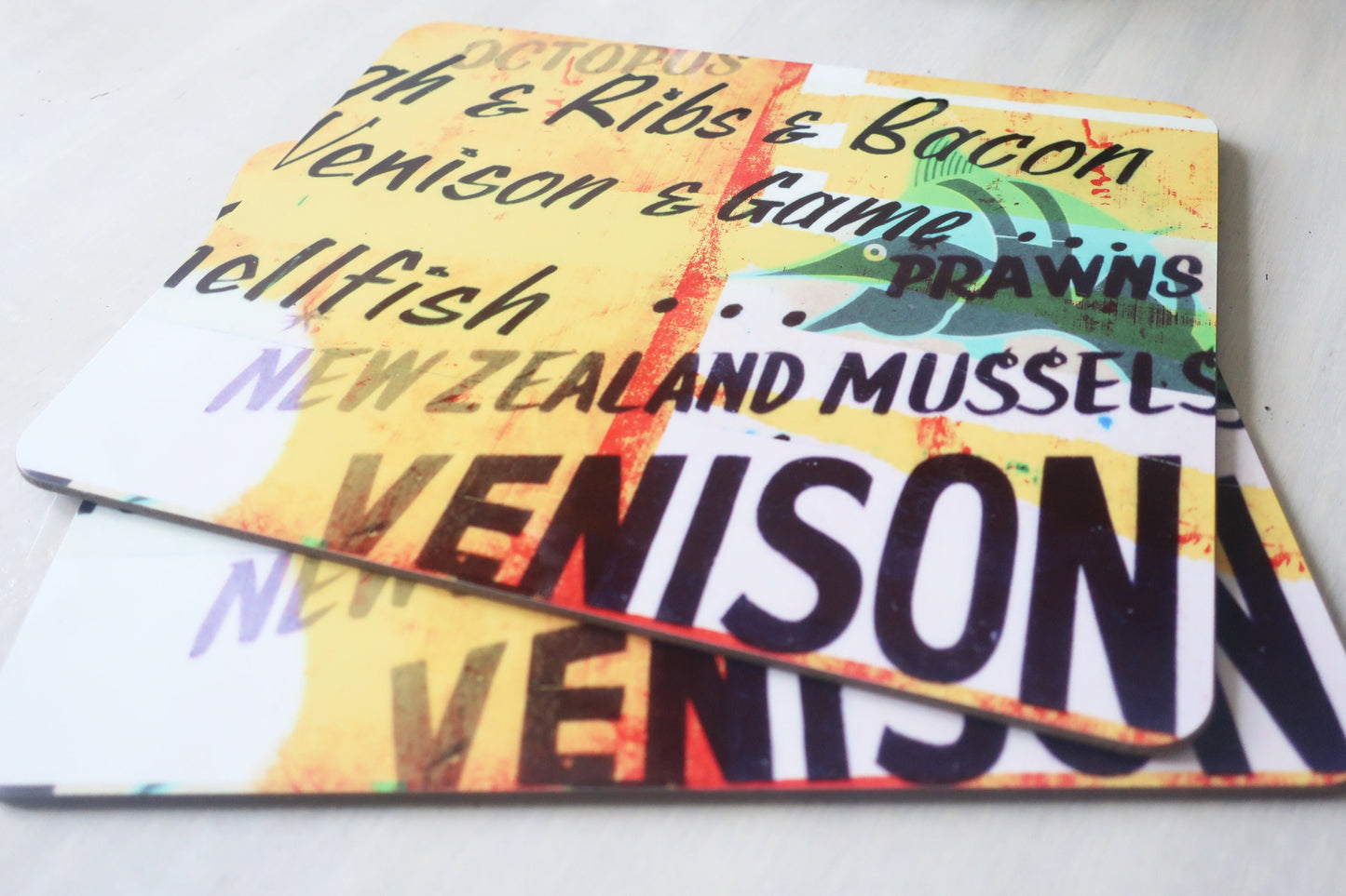 Colorful placemat  with text about New Zealand food items on a white background