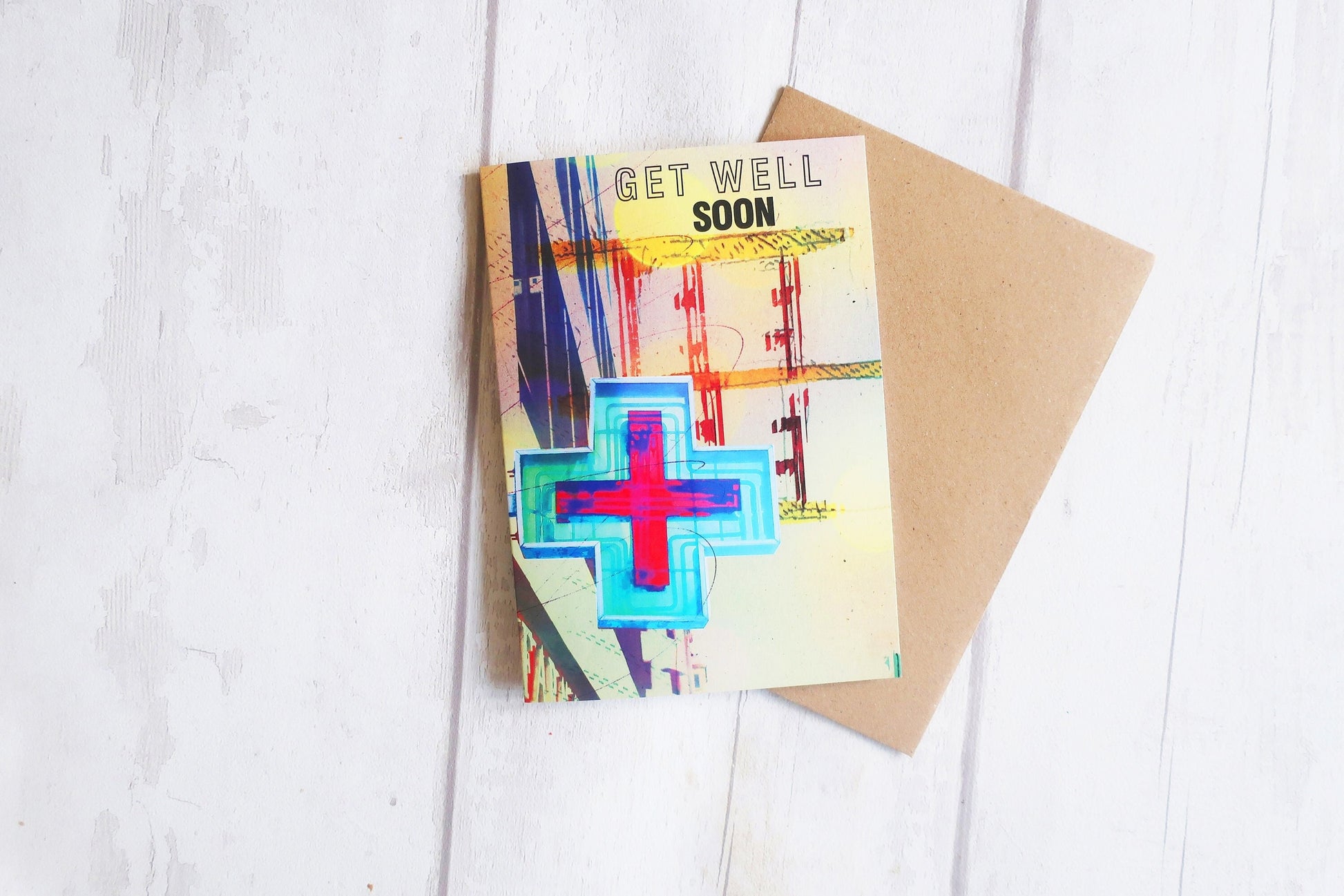 Get well soon card with colorful design on a white wooden surface