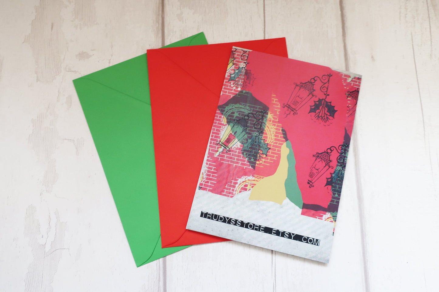 Colorful greeting cards and envelopes on a light wooden surface