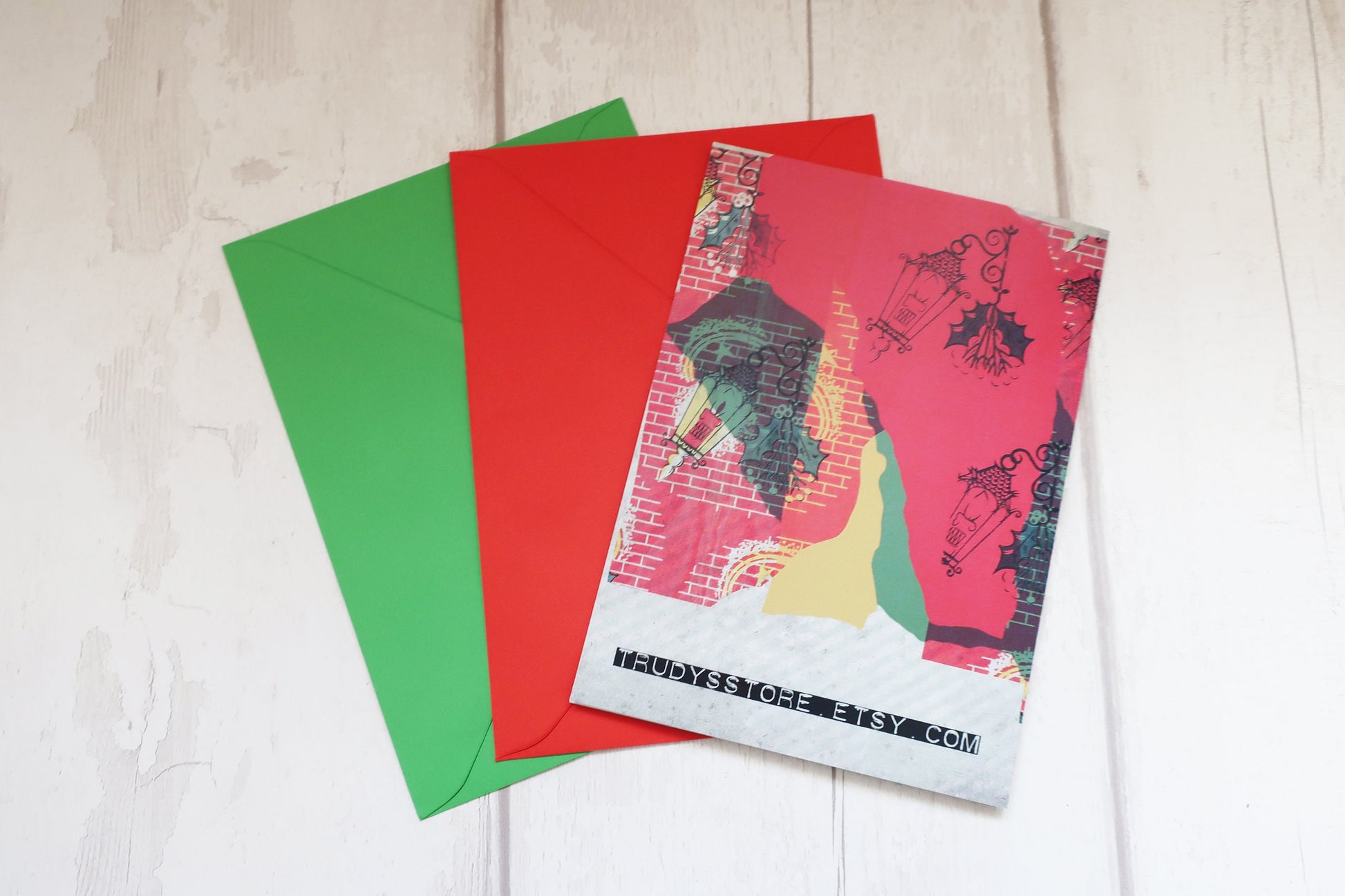 Colorful greeting cards and envelopes on a light wooden surface