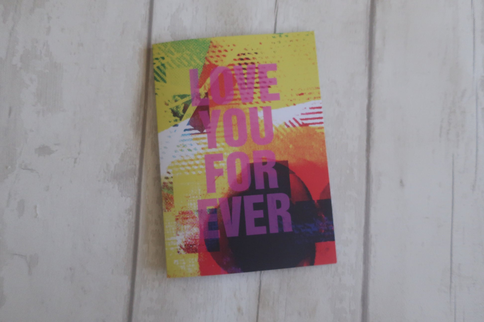 Colorful Greeting card  with 'LOVE YOU FOR EVER' text on a wooden surface