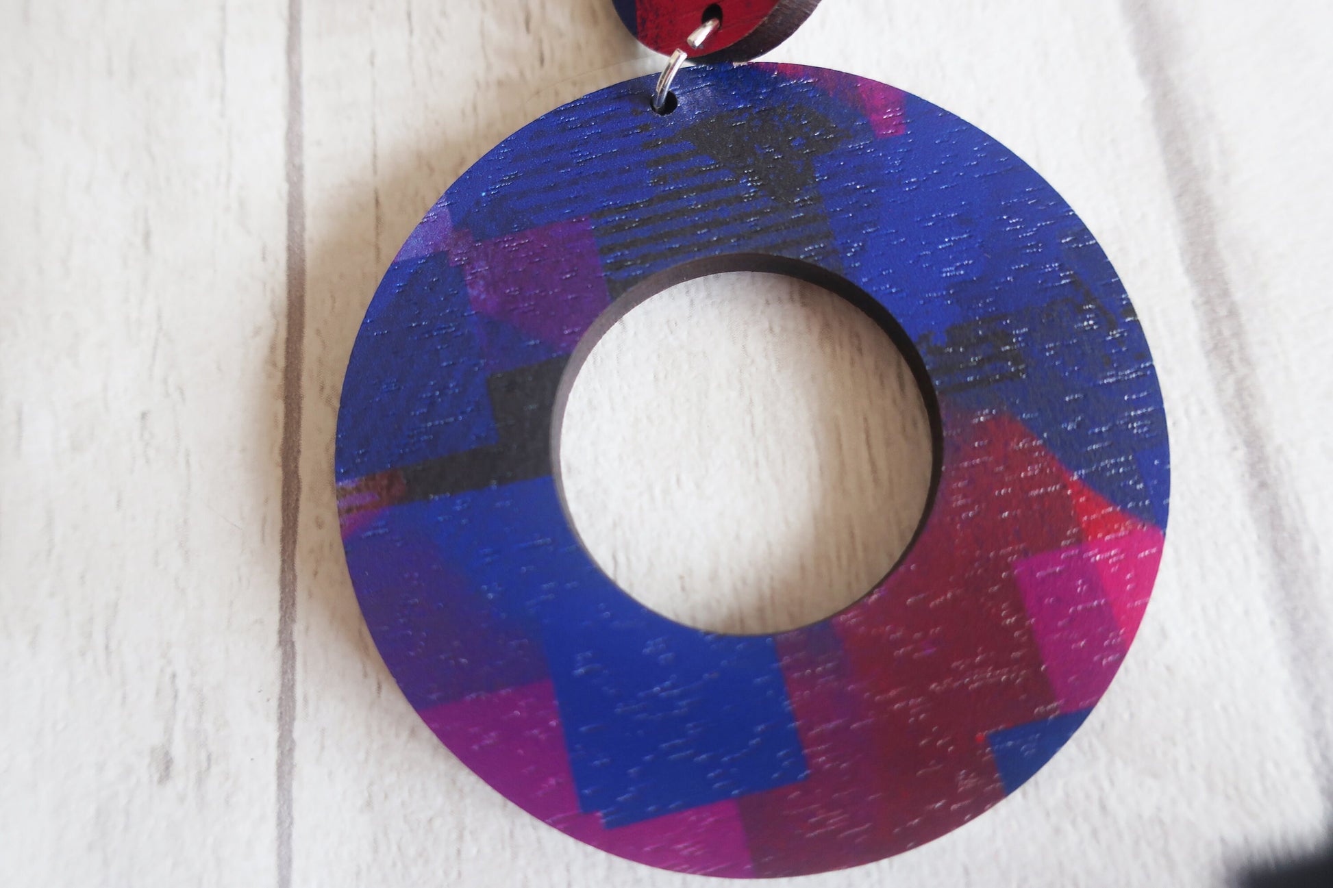 Colorful circular object with a textured surface on a light wooden background