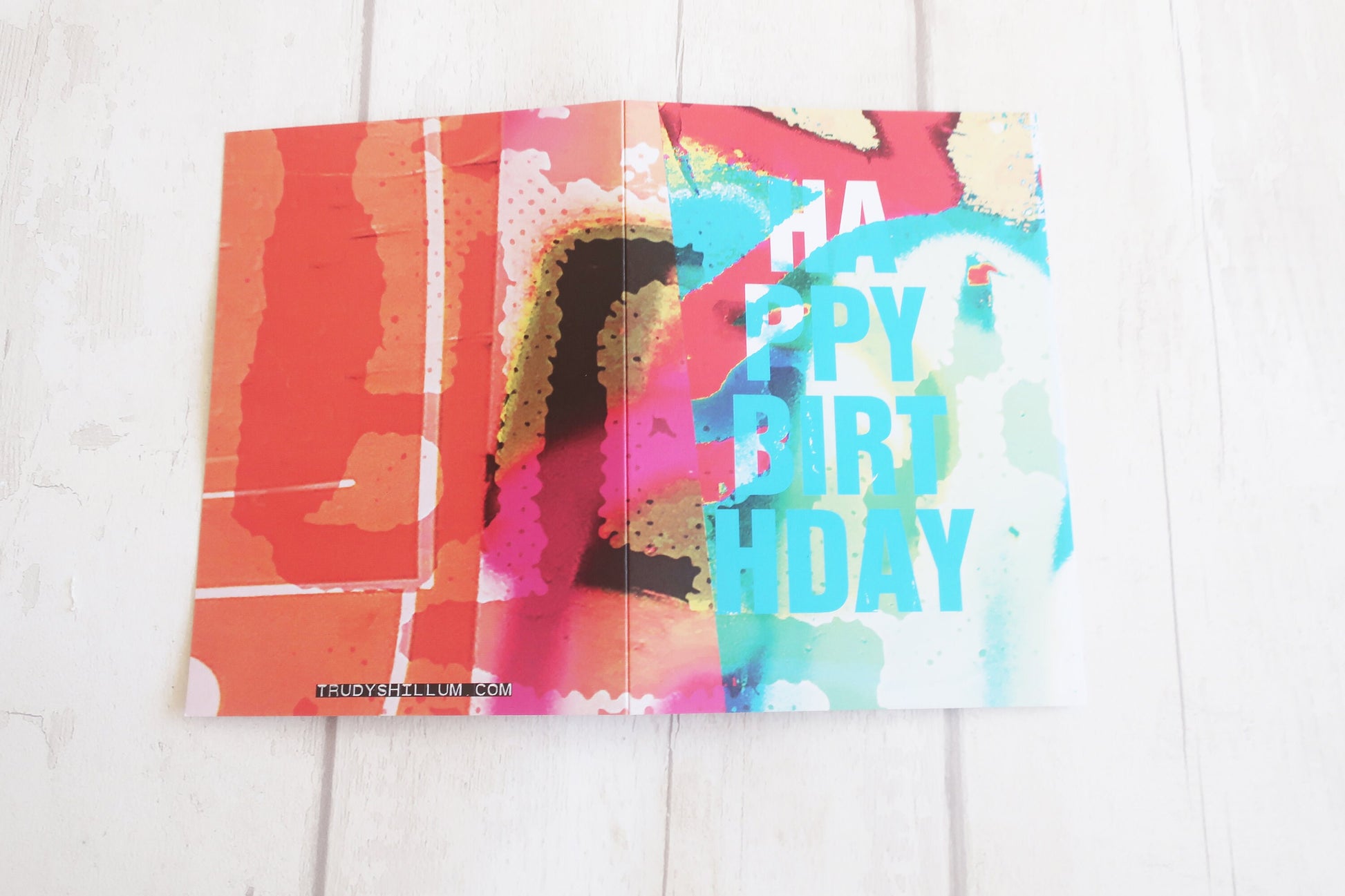 Colorful birthday card with a colorful design on a white wooden surface