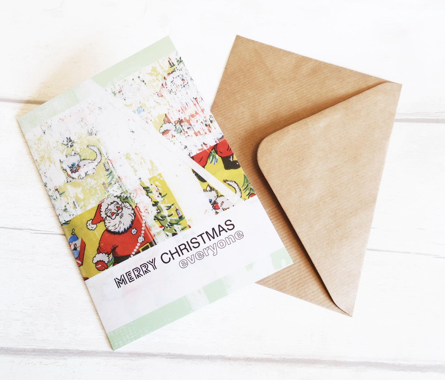 Christmas card with Santa Claus design and a brown envelope on a white background