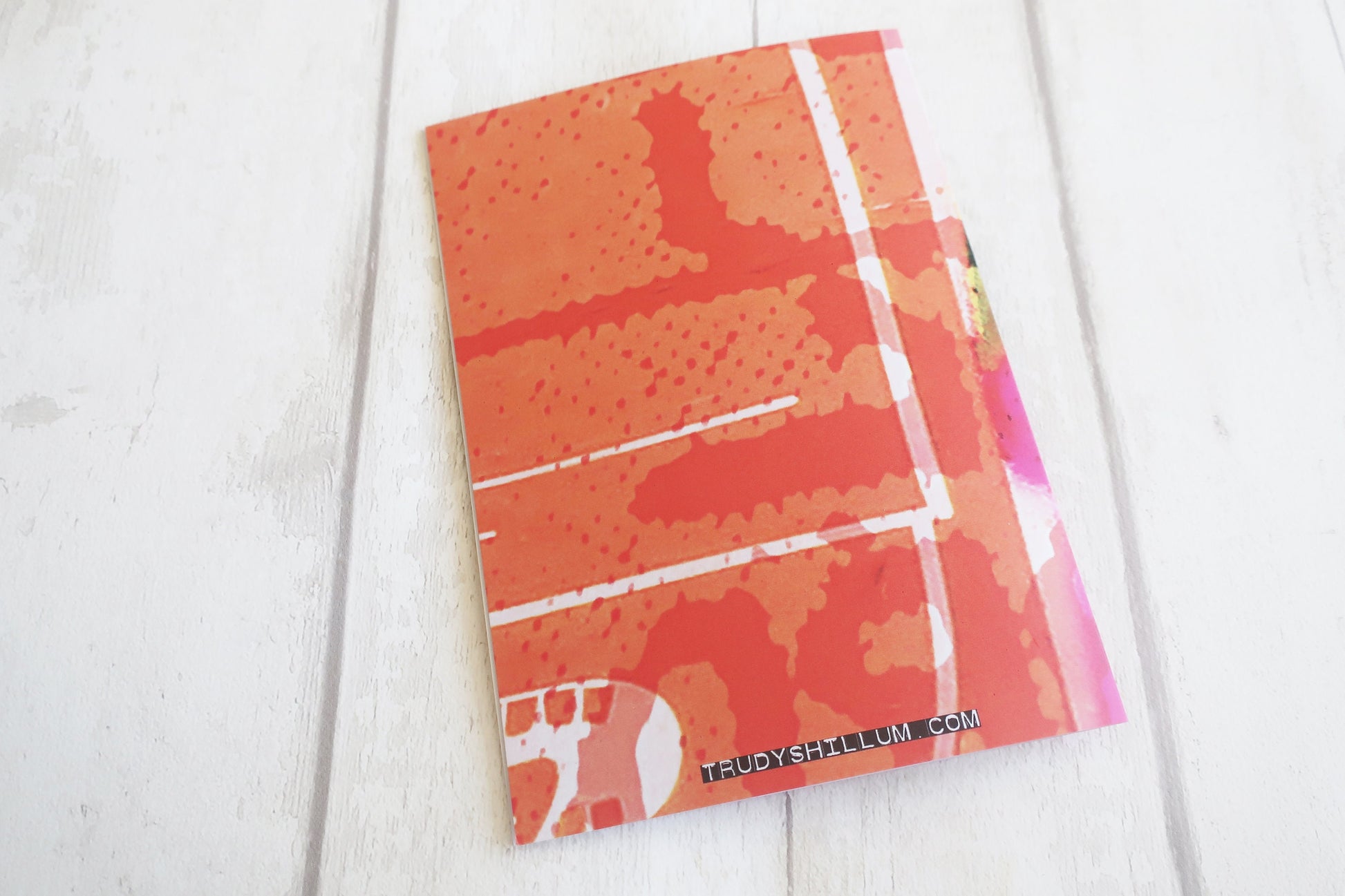 Card back with a colorful abstract design on a white surface