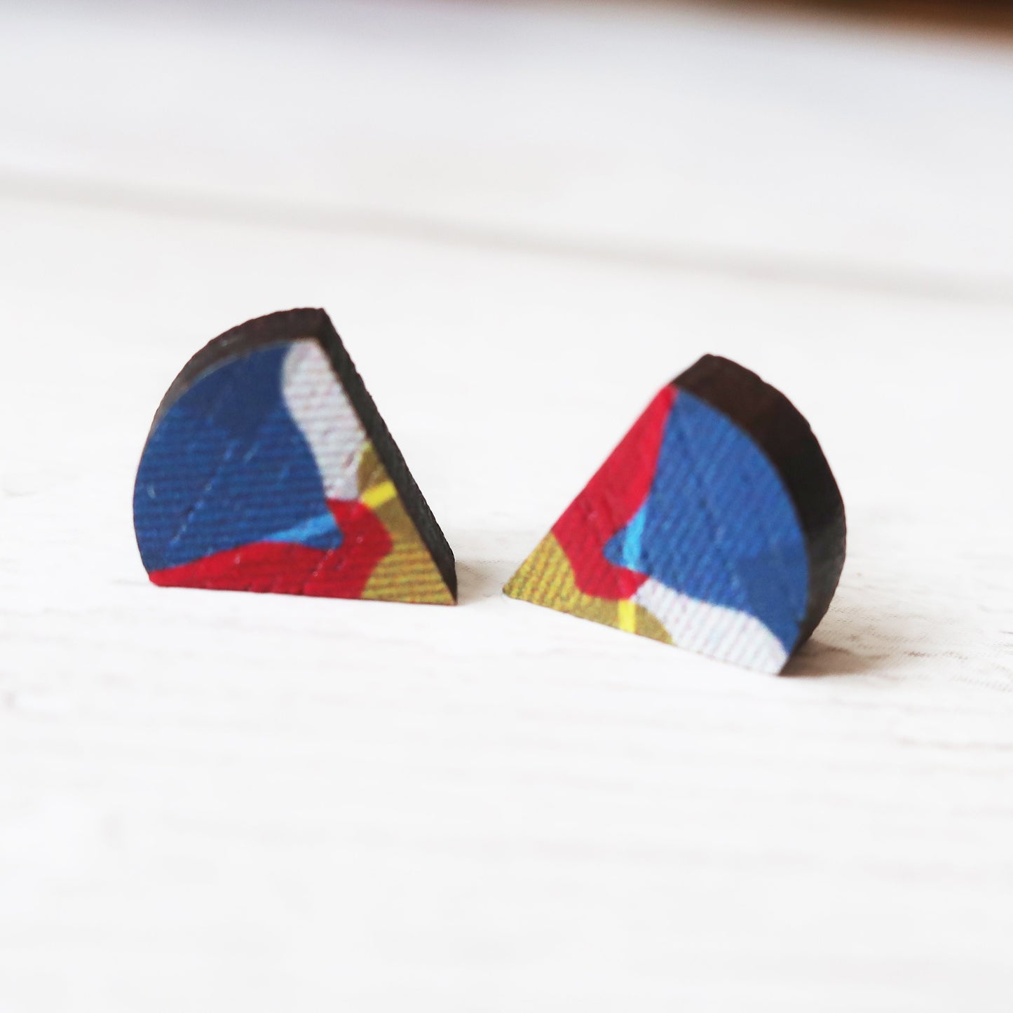 Pair of geometrically patterned earrings on a white background
