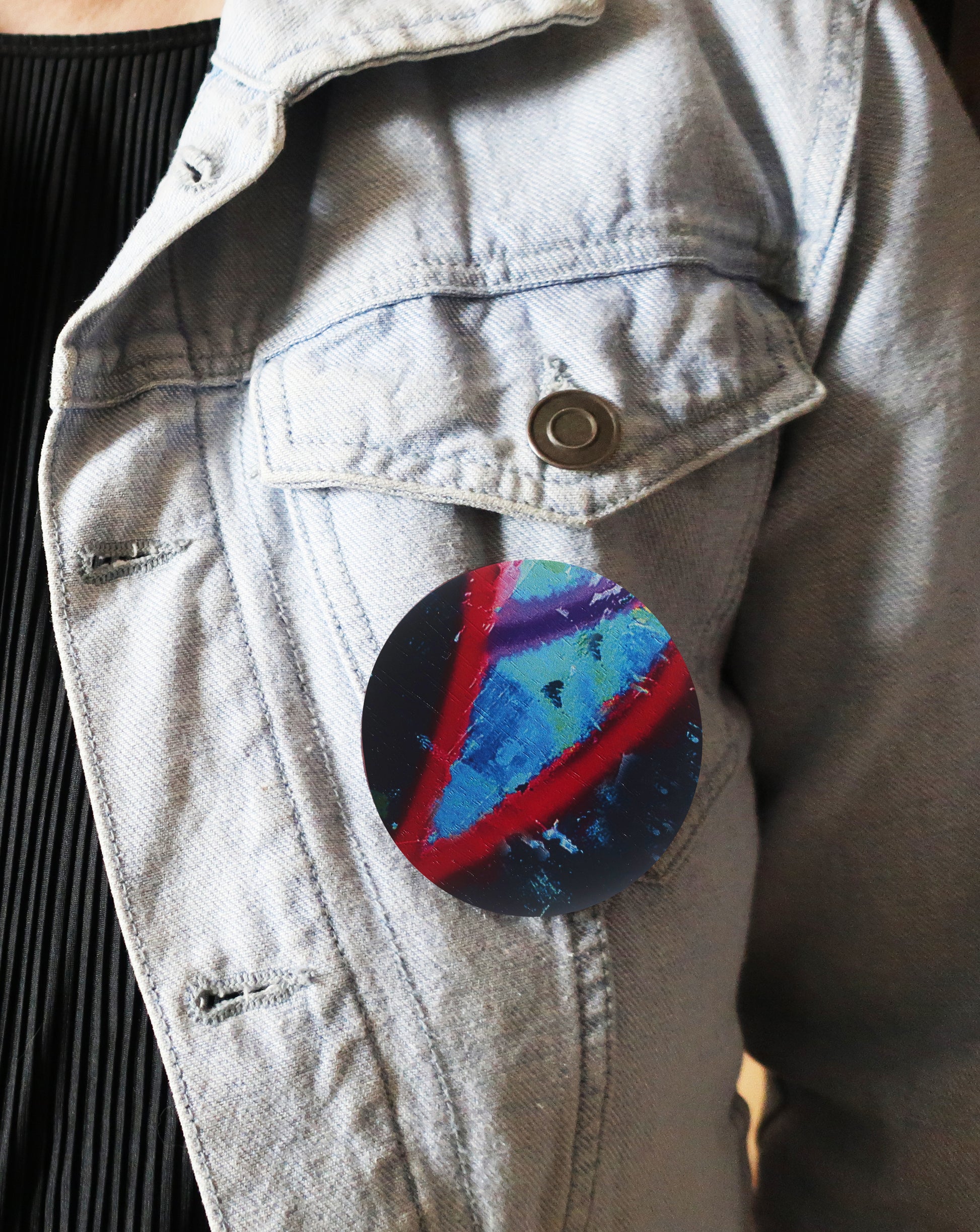 Colorful triangle design brooch on a denim jacket