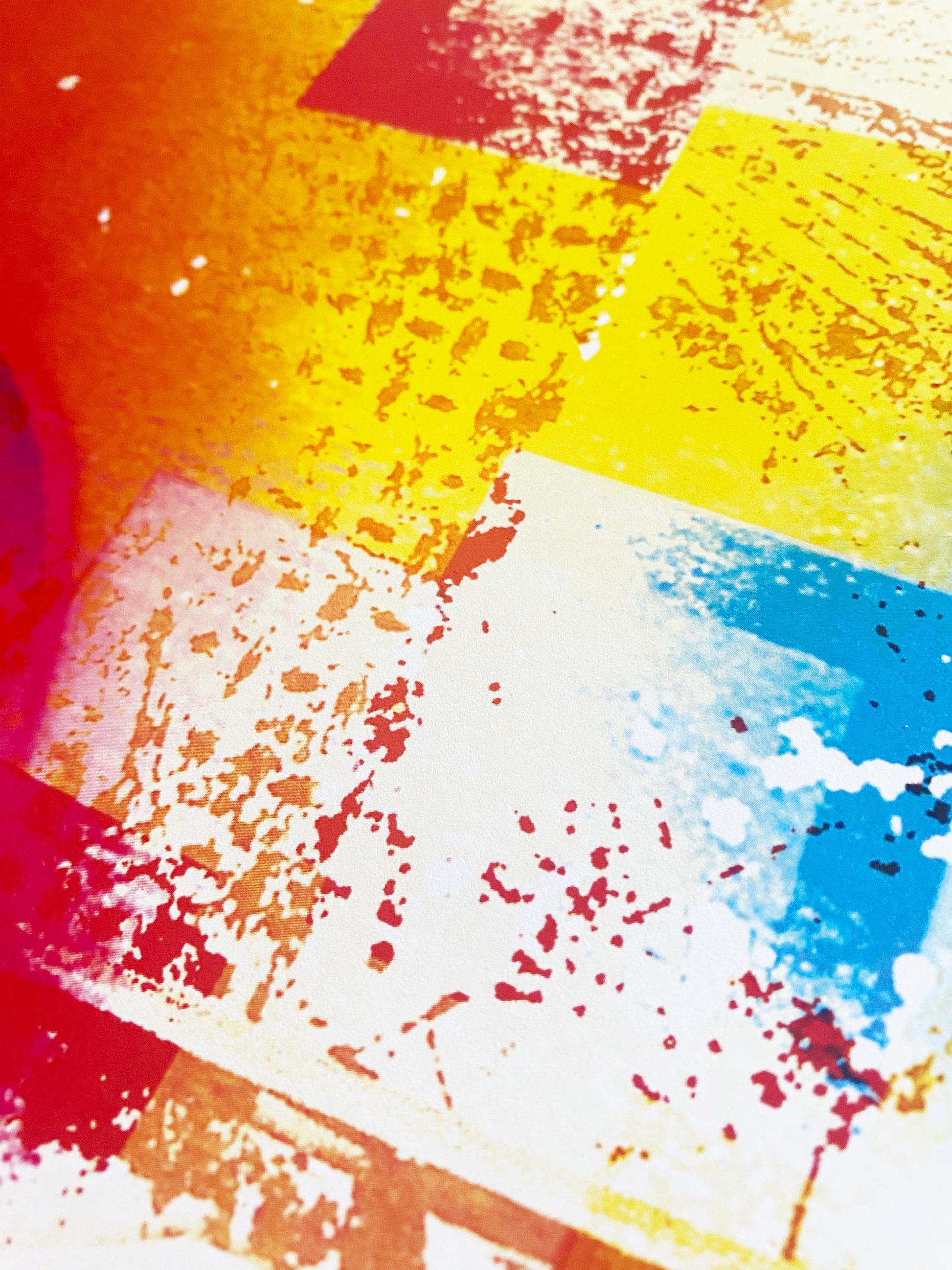 Colorful abstract art with splashes of red, yellow, blue, and orange.
