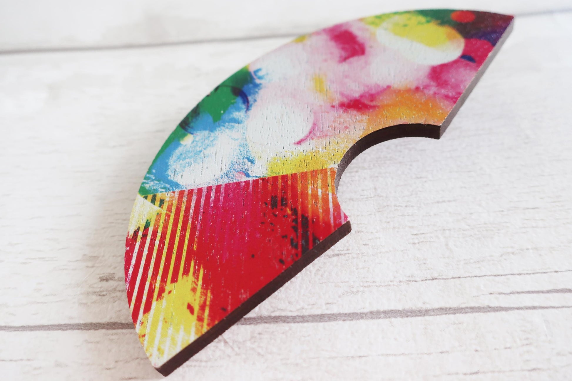 Colorful abstract hairclip on a wooden surface