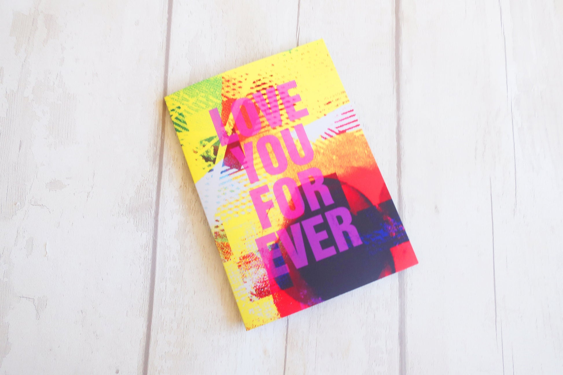 Colorful Greeting card with 'Love You For Ever' text on a white wooden surface