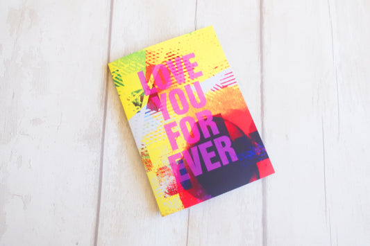 Colorful Greeting card with 'Love You For Ever' text on a white wooden surface